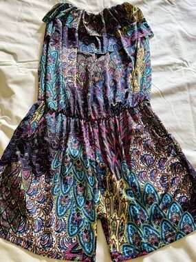 Bohemian-style strapless ruffle-top romper featuring colorful paisley